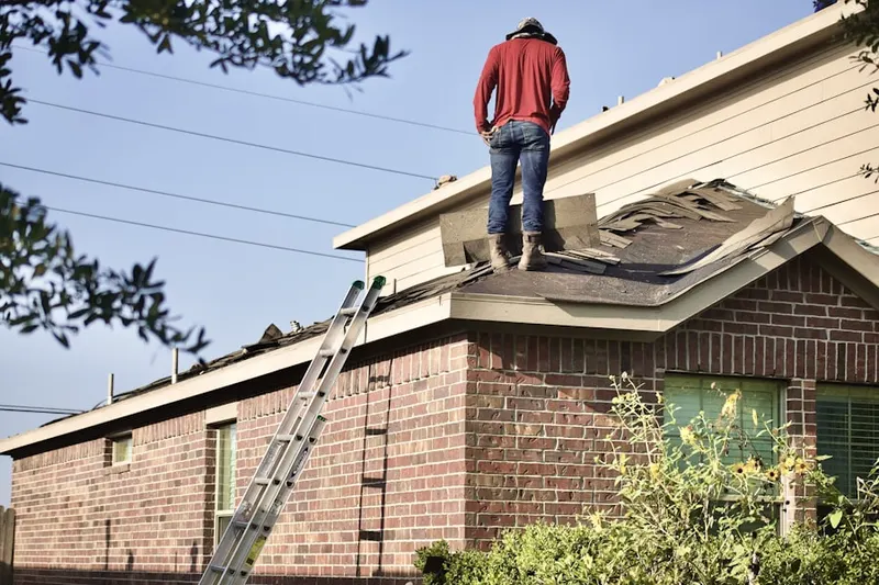 Professional roofer working on a residential roof in Montrose Village